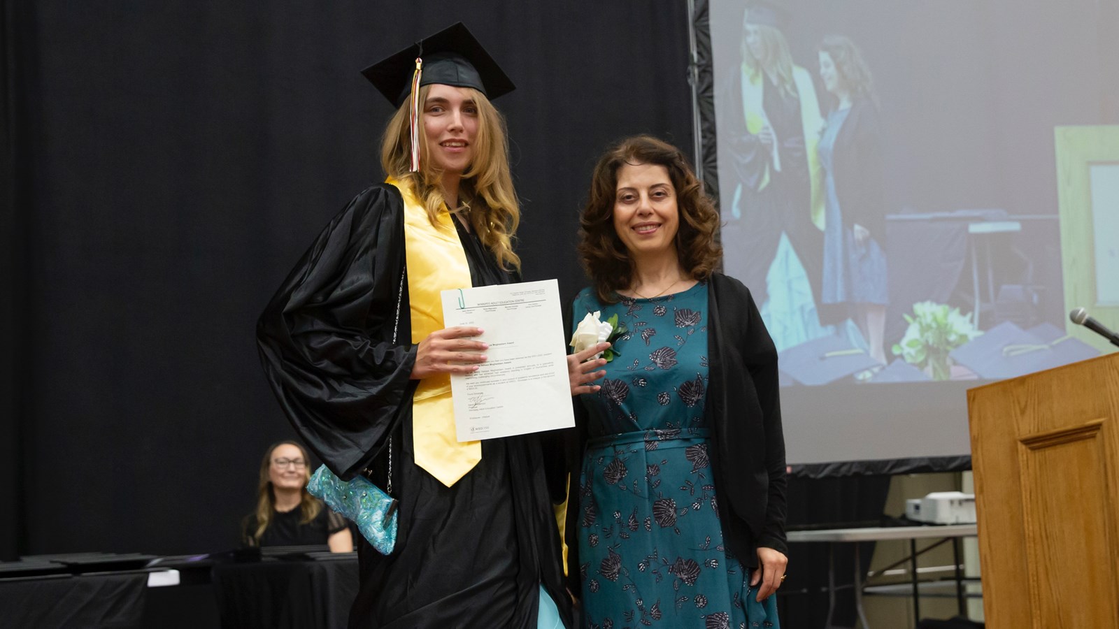 Dr. Maria Sabaye Moghaddam presents her inaugural humanities award to WAEC graduate Jaime Rose Reimer.